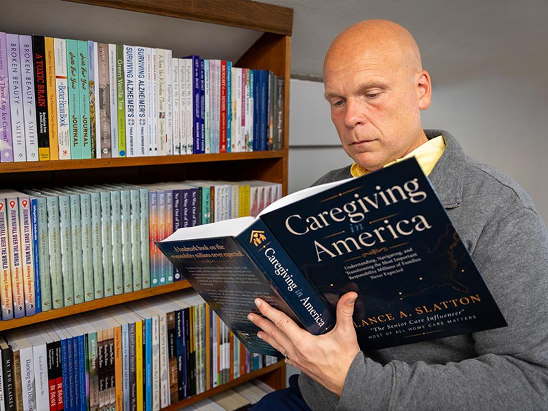Lance A. Slatton holding Caregiving in America